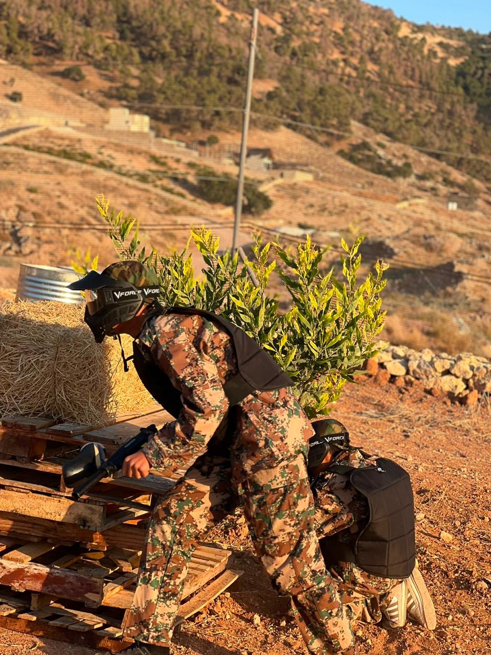لاعبان يتقدّمان بجانب بالة قش وساتر من المنصّات الخشبية